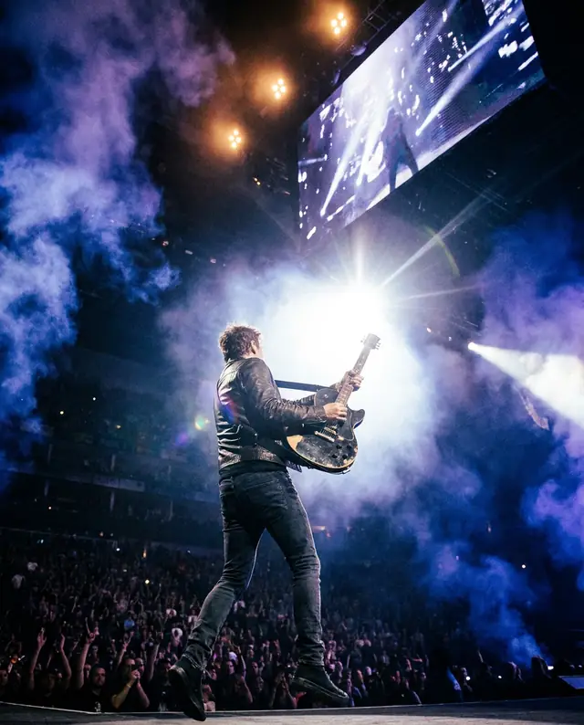 A guitarist on stage (illustrative image, fictional artist)